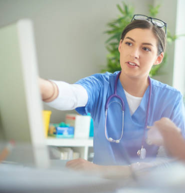Nurse pointing to screen.
