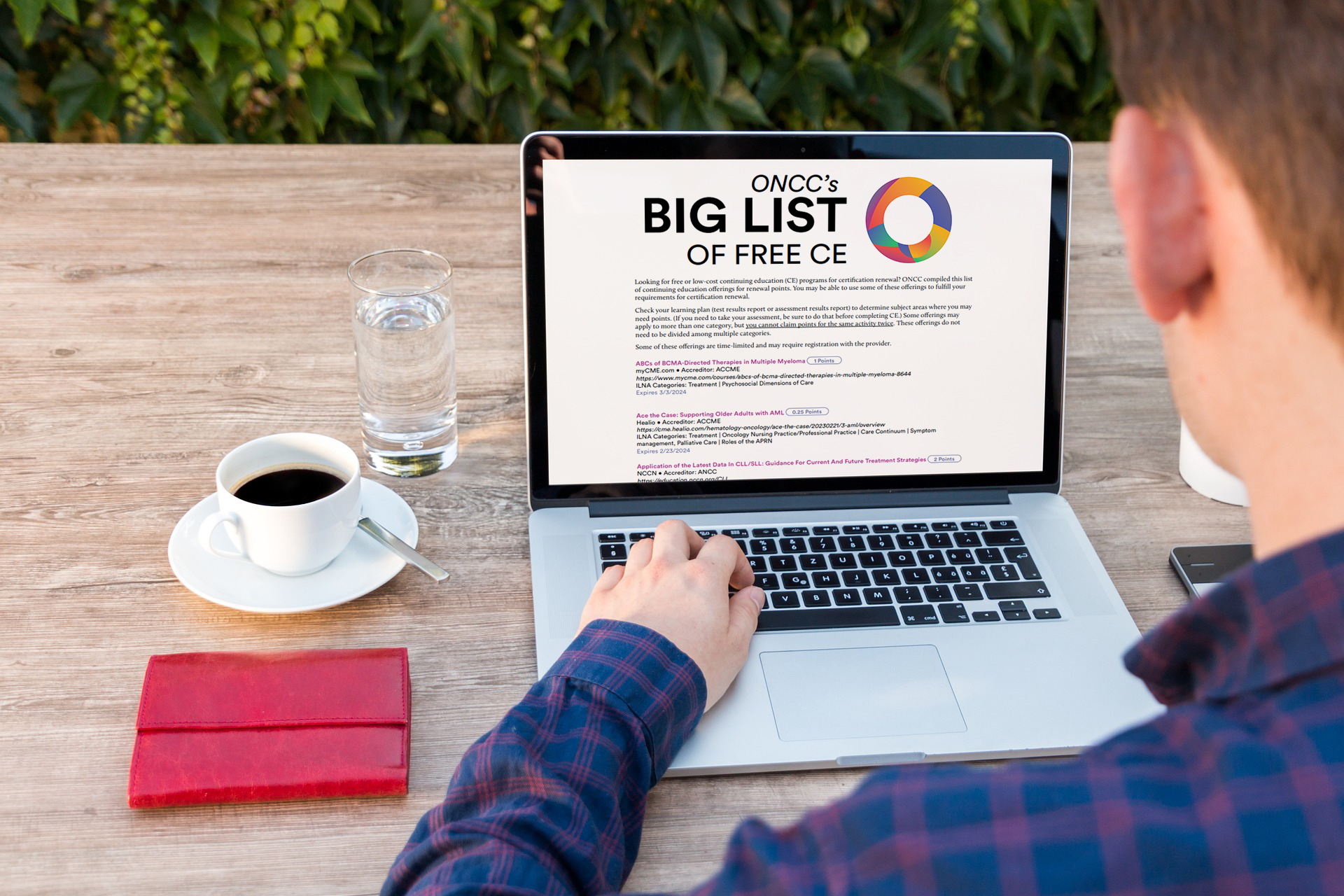 Person accessing Big List of Free CE on laptop
