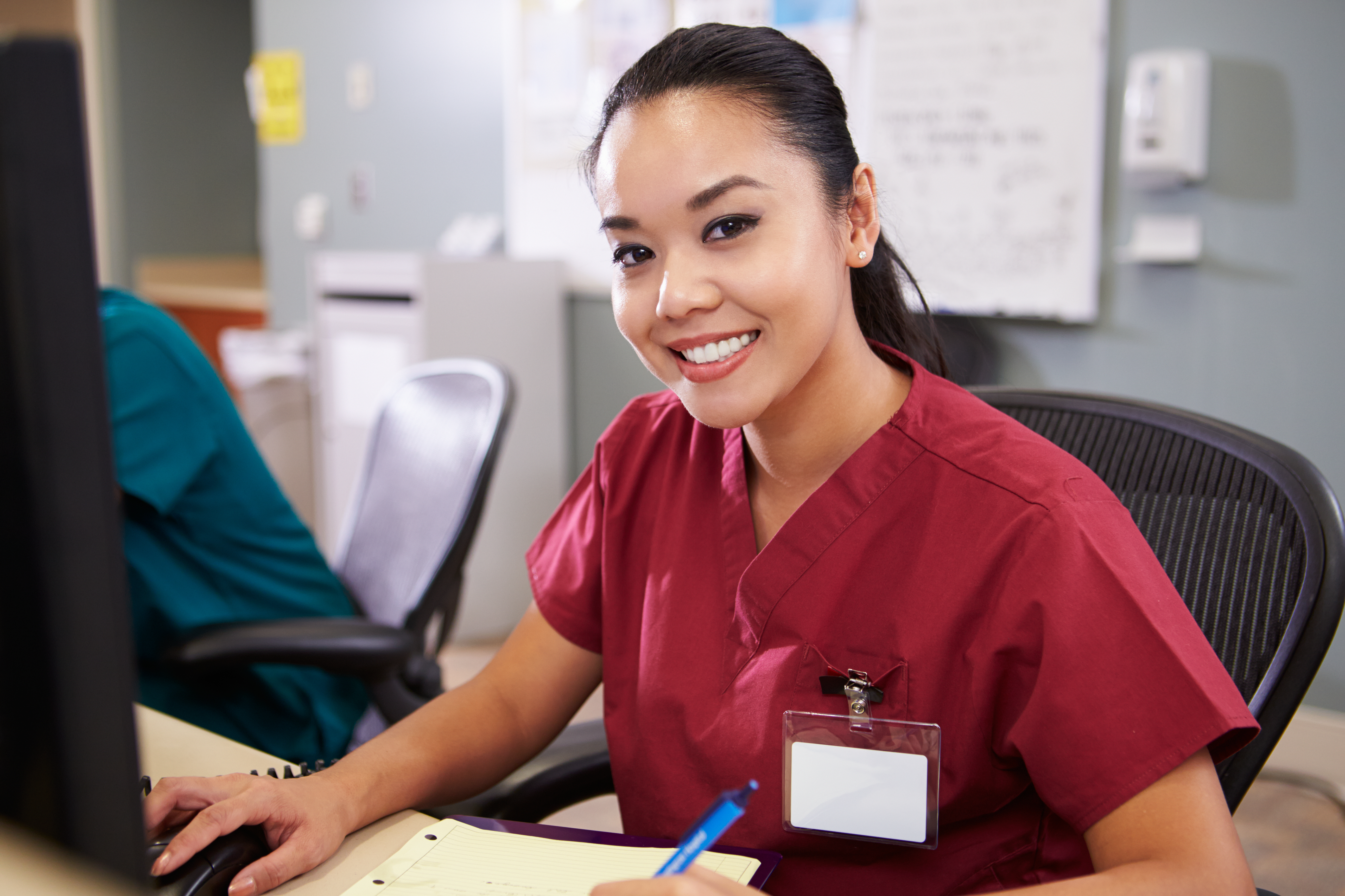 female nurse sitting at computer