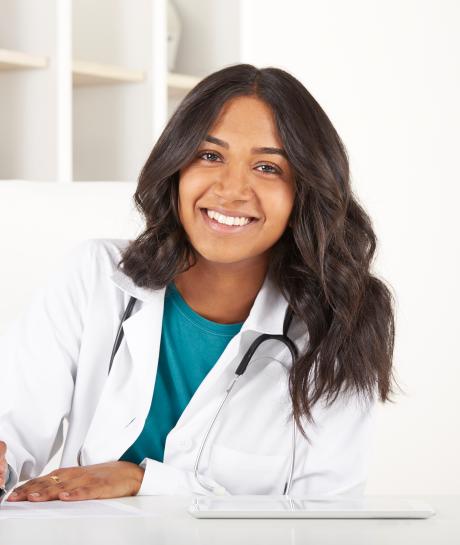 Nurse sitting at desk and writing