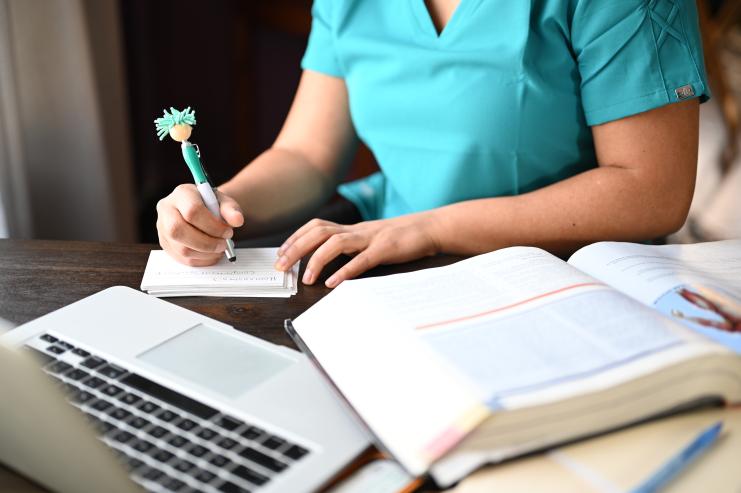 Nurse writing notes studying