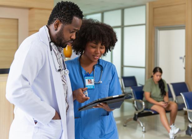 Nurse and doctor reviewing clipboard